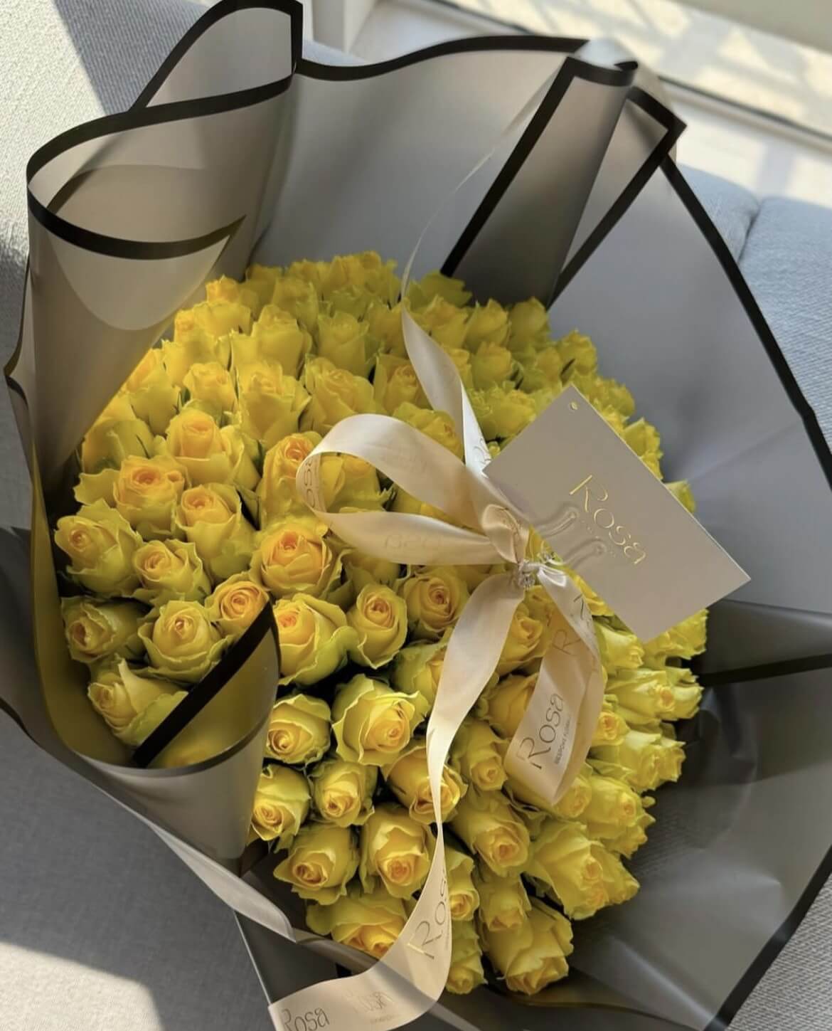 80 yellow roses in black wrapping - 1 business day lead time required