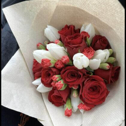Red roses, mini carnations & tulips (tulips will be substituted with another color if unavailable)