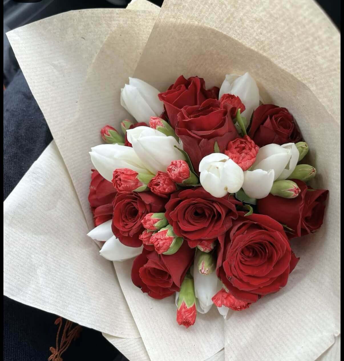 Red roses, mini carnations & tulips (tulips will be substituted with another color if unavailable)