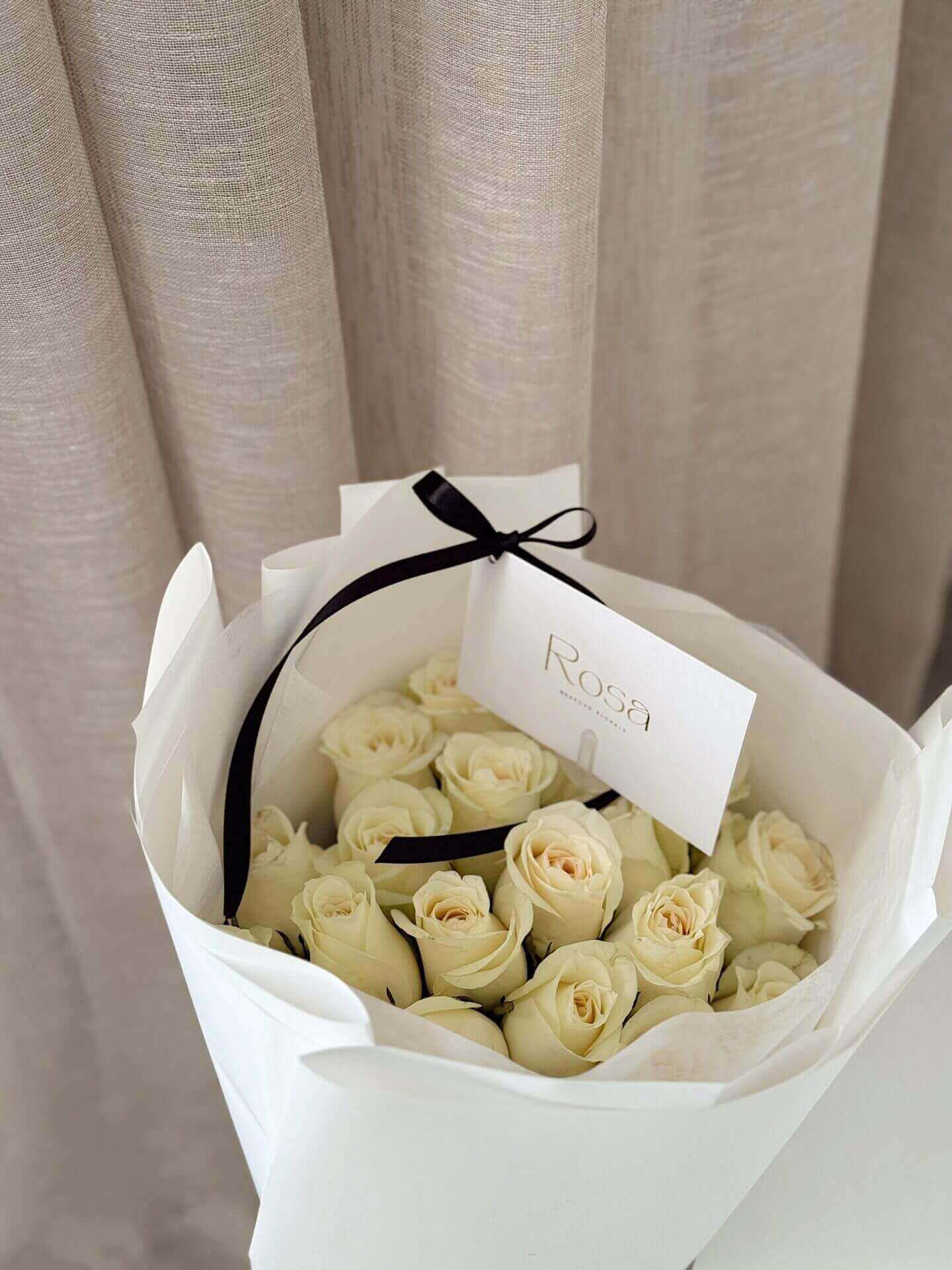 20 white roses in white wrapping