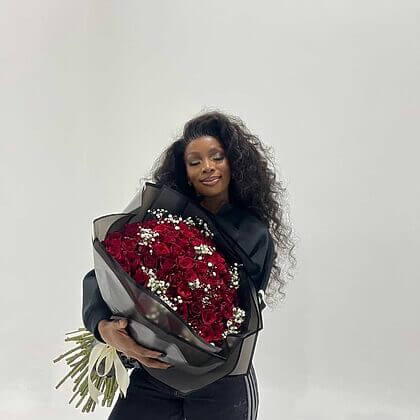 Red roses with baby breath inbetween- black wrapping