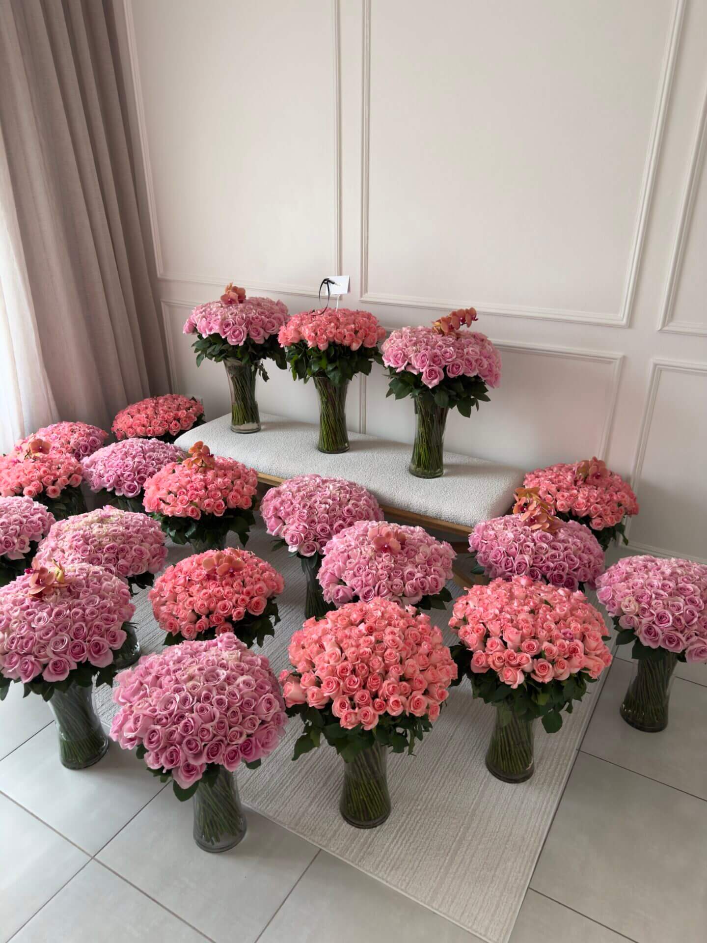 2000 pink roses in vases with orchids ontop